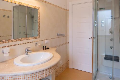 a bathroom with a sink and a shower at NONNU NONNA in Padru