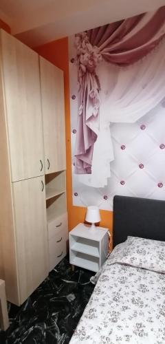 a bedroom with a bed and a dresser and a wall at Céline in Genova