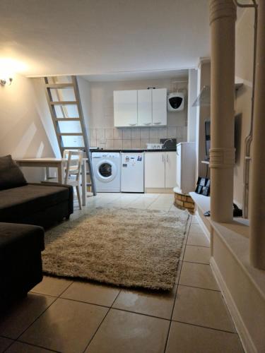 a living room with a couch and a kitchen at Armhurst in London