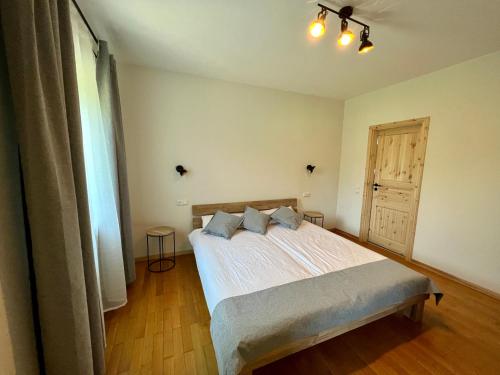 a bedroom with a large bed and a window at Aparthotel Hochfeld in Schönau am Königssee