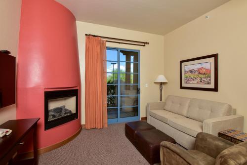 a living room with a couch and a fireplace at Lodge On The Desert in Tucson