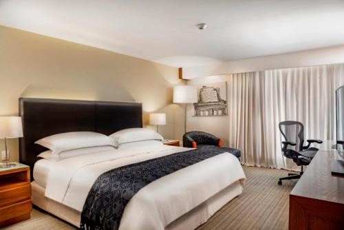 a hotel room with a bed and a desk at Presidente InterContinental Puebla by IHG in Puebla