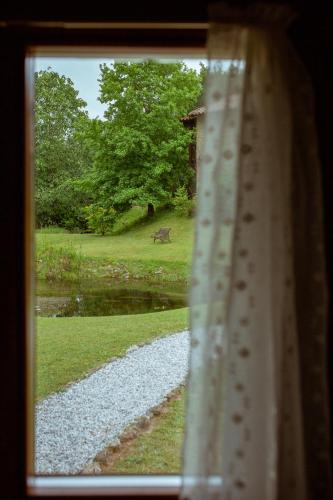 a view from a window of a deer in a field at El Molino de Bonaco in San Vicente de la Barquera