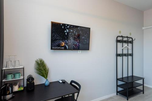 a room with a table and a picture on the wall at 2NIGHT in Šventoji in Palanga