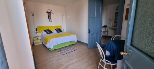 a bedroom with a bed and a cross on the wall at ICCE HOTEL in Santiago