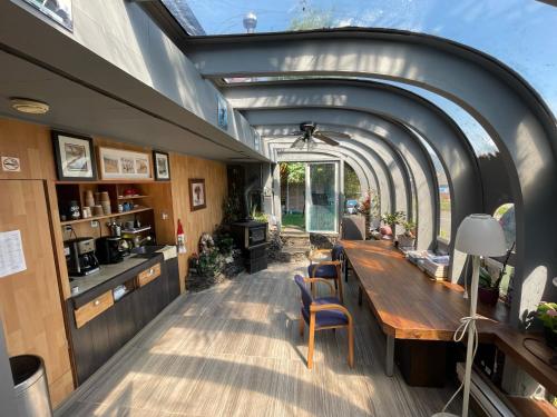 an internal view of the kitchen and dining room of a tiny house at Schooner Motel in Tofino