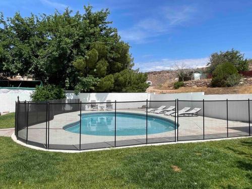 a fence around a swimming pool in a yard at Cozy Adventure Casita in St. George