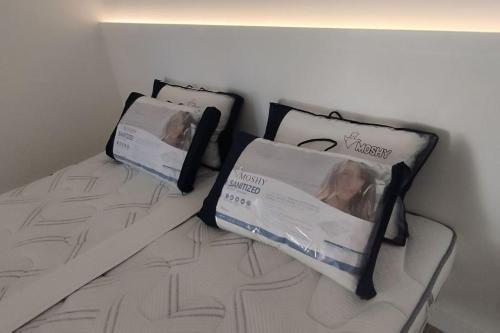 two pillows sitting on a bed in a room at Gîte Aux Bons Voisins in Gordes