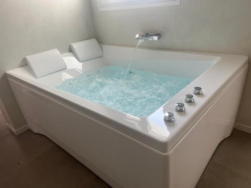 a bath tub with a water fountain in it at SPA JUNGLE in Le Mesnil-Saint-Denis