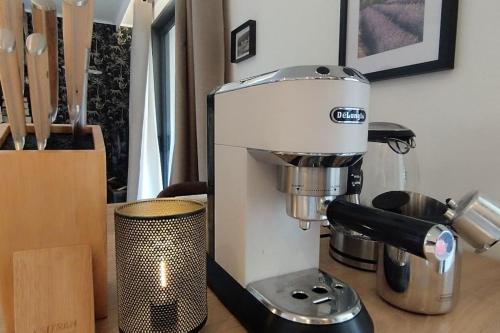 a mixer sitting on a counter next to a container at Gîte Aux Bons Voisins in Gordes