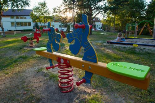 a park with a playground with a slide at Hotel Niedźwiadek in Wdzydze Kiszewskie