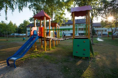 a playground with a slide in a park at Hotel Niedźwiadek in Wdzydze Kiszewskie