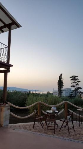 a table and chairs sitting on a patio at Momentum Θ in Maleme