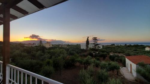 a view of the sunset from the balcony of a house at Momentum Θ in Maleme