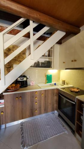 a kitchen with wooden cabinets and a staircase in a room at Momentum Θ in Maleme