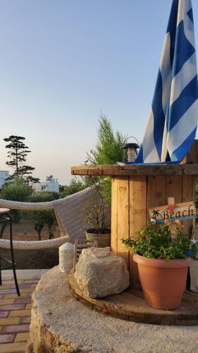 a patio with an umbrella and some plants and a table at Momentum Θ in Maleme