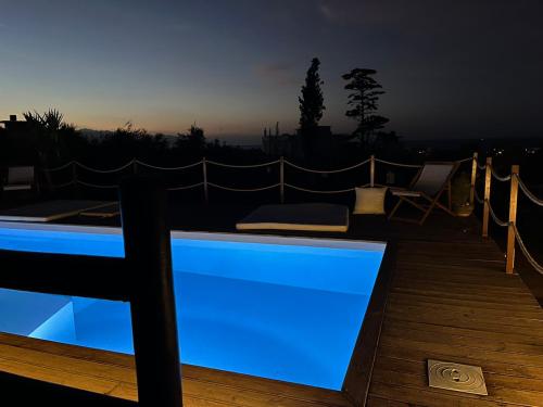 a swimming pool on a deck at night at Momentum Θ in Maleme