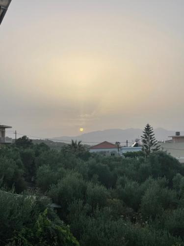 a view of the sunset from the roof of a house at Momentum Θ in Maleme