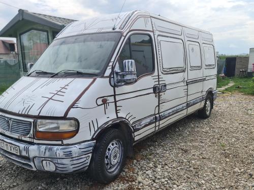 a white van is parked in a driveway at Camper Niklas in Vama Veche