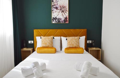 a bedroom with a large bed with yellow accents at Mediterra 2 in Crikvenica