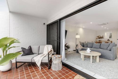 a living room with a couch and a table at Beachside Serenity in Byron Bay