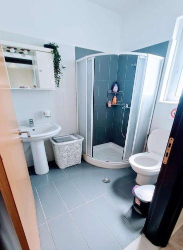 a bathroom with a shower and a toilet and a sink at Retas apartment up in Kremasti