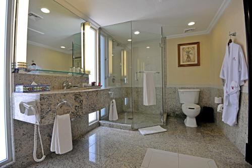 a bathroom with a shower and a toilet and a sink at Marriott Torreon Hotel in Torreón