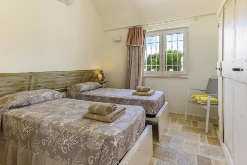 Lova arba lovos apgyvendinimo įstaigoje Villa Trullo Oro Verde by Villa Plus