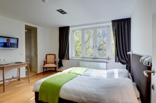 Ένα ή περισσότερα κρεβάτια σε δωμάτιο στο Hotel Le Clos des Récollets
