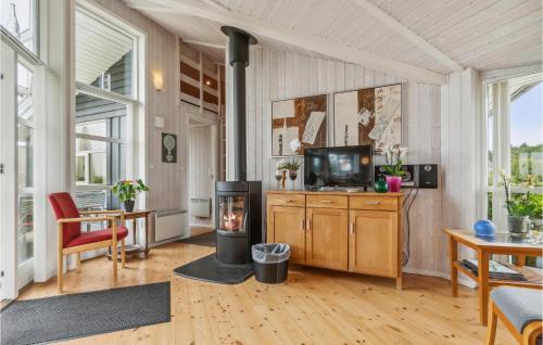 a living room with a fireplace and a television at Holiday Home Løjtnantvænget Rudkøbing V in Spodsbjerg