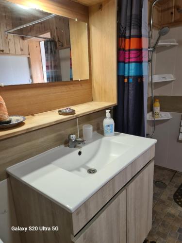 a bathroom with a sink and a mirror at AL Luso Brasileiro in Lajes das Flores