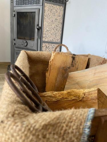 a pile of wood sitting on top of a couch at Casinha da Ti'Augusta in Lamego
