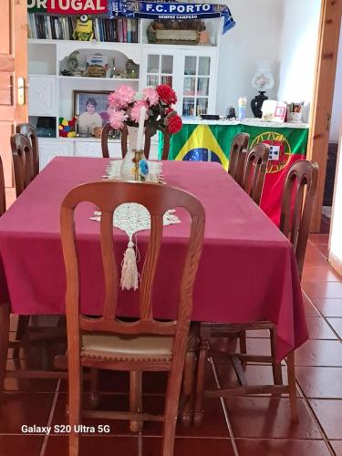 a dining room table with a pink table cloth at AL Luso Brasileiro in Lajes das Flores