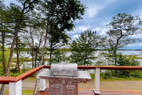 a grill on a deck with a view of the water at Lobster Shack in Boothbay