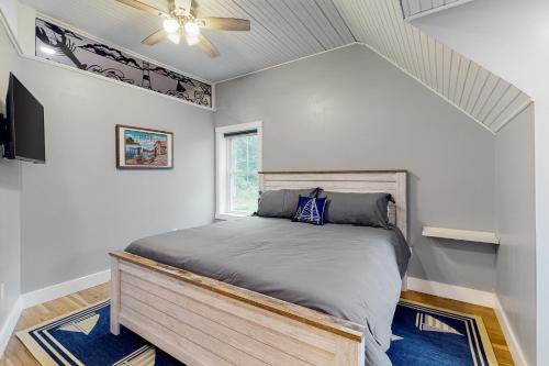 a bedroom with a bed and a ceiling fan at Lobster Shack in Boothbay
