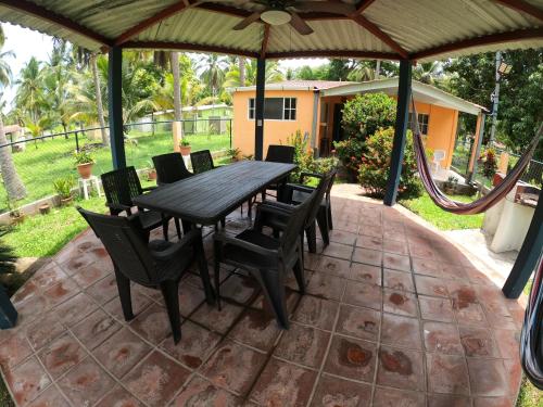 a wooden table and chairs on a patio at SALIMAR - Barra de Santiago in Barra de Santiago