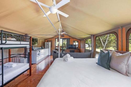 a bedroom with a bed and a ceiling fan at Reflections Mylestom - Holiday Park in Mylestom
