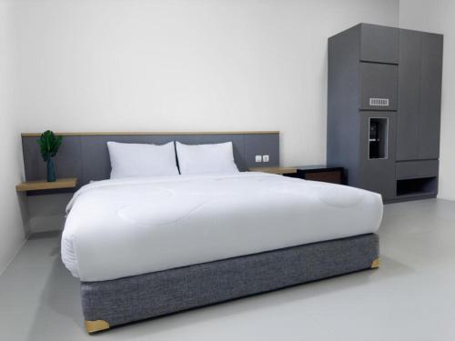 Ένα ή περισσότερα κρεβάτια σε δωμάτιο στο Uresidence Bengkulu