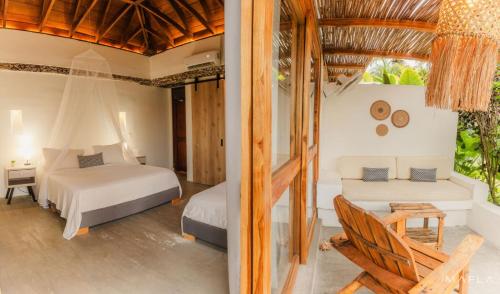 a bedroom in a villa with two beds at Rosario EcoHotel in Isla Grande