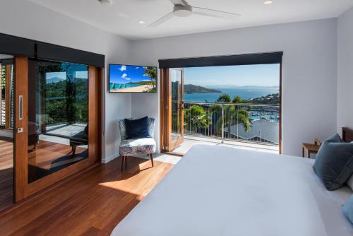 a bedroom with a bed and a view of the ocean at Horizons on Hamilton Island by HIHA in Hamilton Island