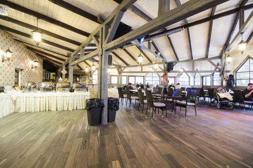 a dining room with tables and chairs in a building at Hotel Niedźwiadek in Wdzydze Kiszewskie