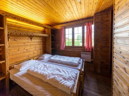 a bedroom with a bed in a wooden cabin at Chalet Comfort Near Durbuy in Barvaux