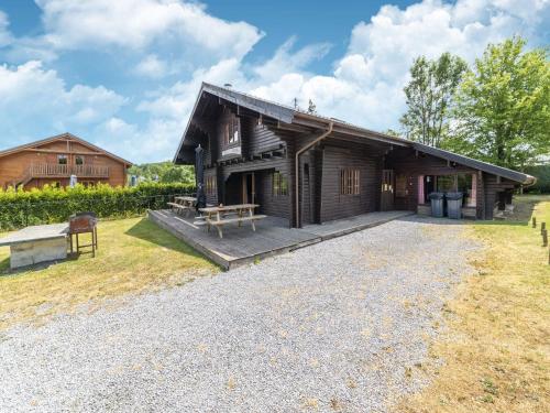 a log cabin with a picnic table in front of it at Chalet Comfort Near Durbuy in Barvaux