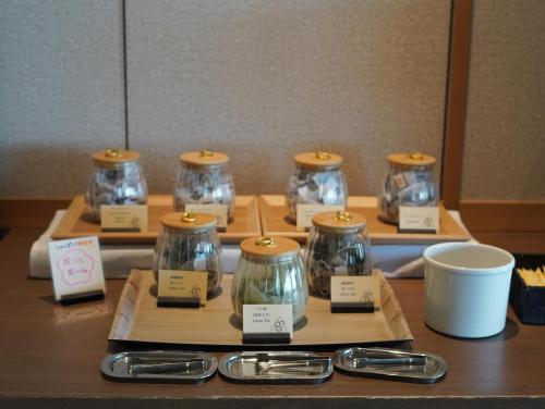 a group of glass jars sitting on a table at KAMENOI HOTEL Izukogen in Ito
