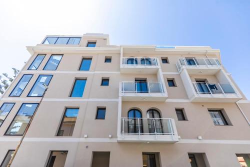 an apartment building with windows and balconies at Solmaris Tropea Rooms & Suites in Tropea