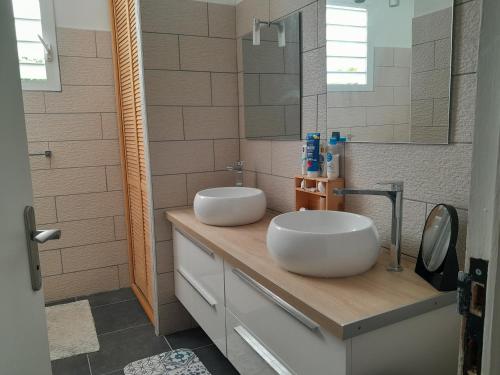 - une salle de bains avec 2 lavabos blancs sur un comptoir dans l'établissement Villa Lovely, à Saint-François