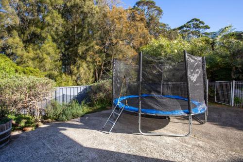 a trampoline with a net in a yard at Reflections Pet Friendly Waterfront in Basin View