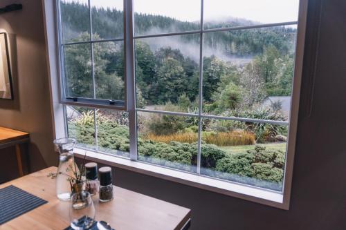a window with a view of a garden at Maruia River Retreat in Shenandoah