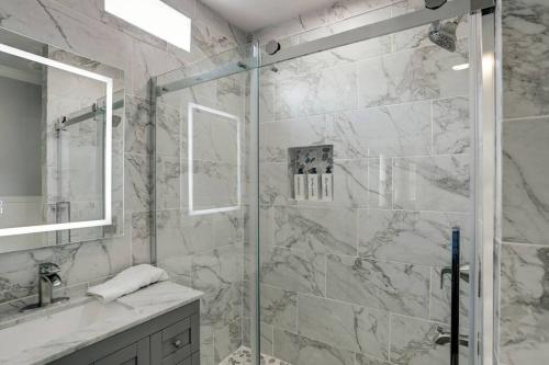 a bathroom with a shower with a glass door at Renovated Beach Bungalow! in Galveston