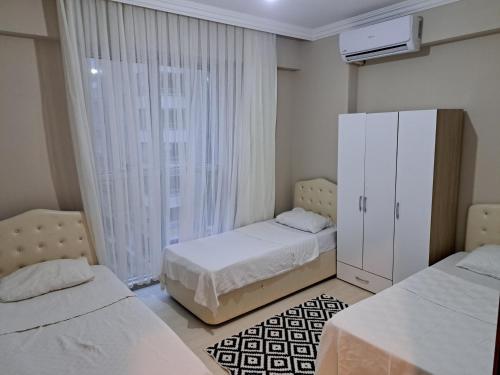 a bedroom with two beds and a large window at AKUA 23 in Trabzon